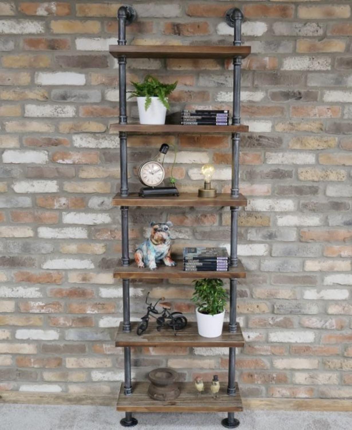 Industrial wood shelving unit with steel pipes.