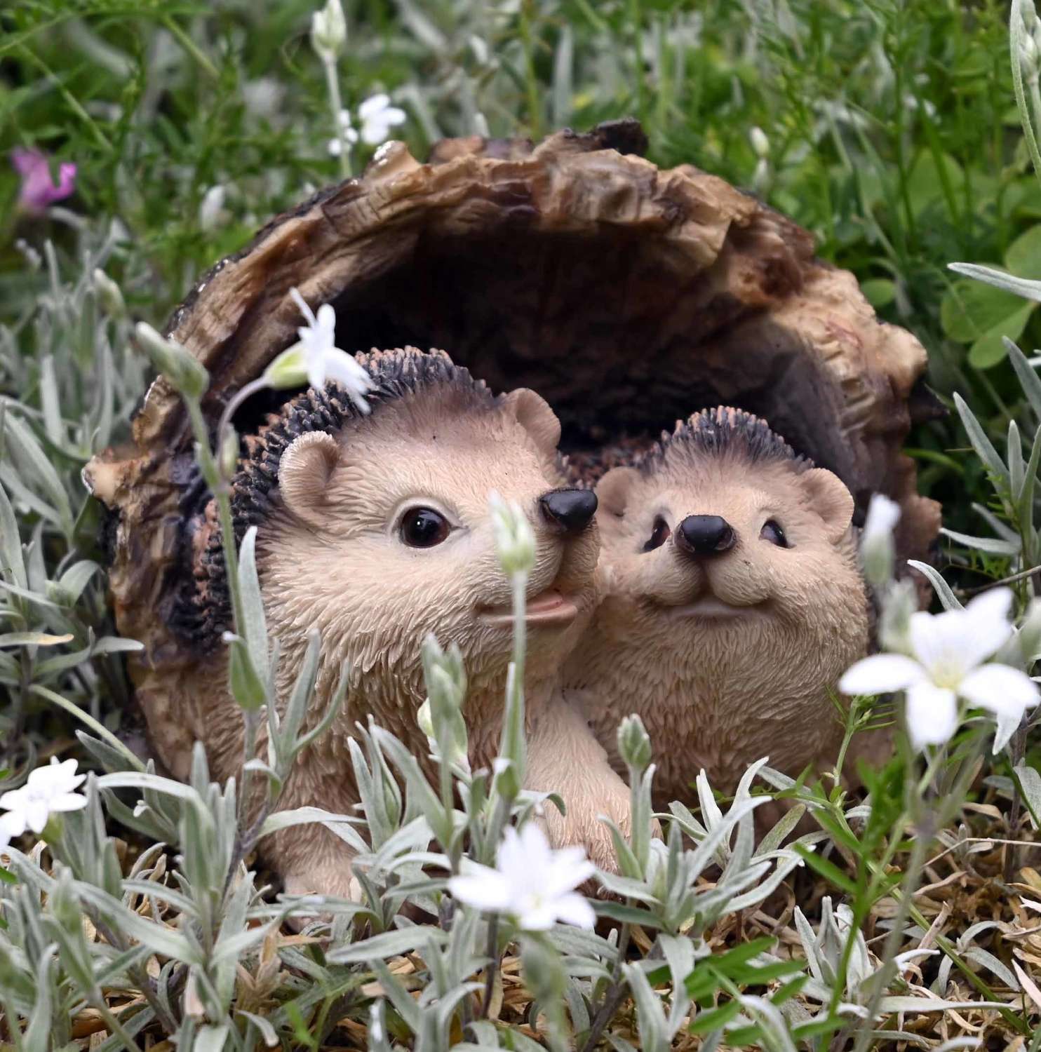 Hedgehogs in log garden ornament
