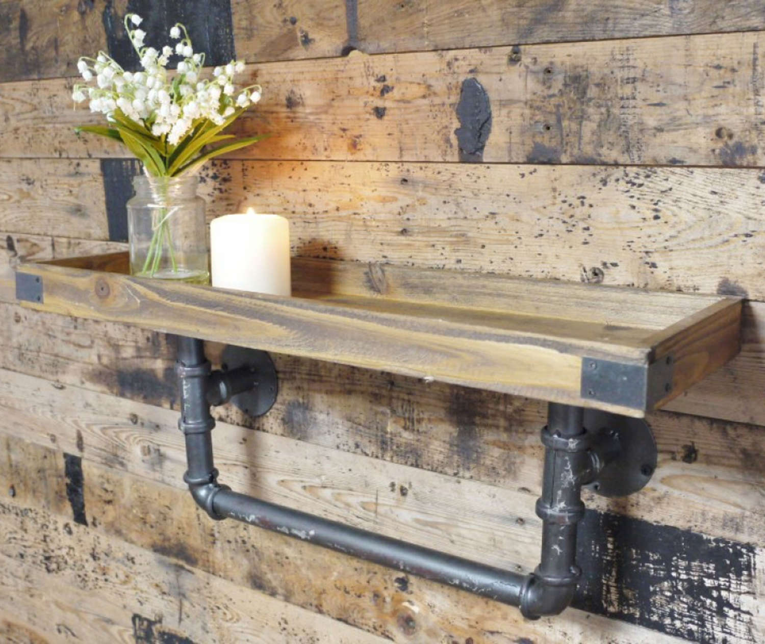 Rustic industrial wooden shelf with distressed effect iron pipework.