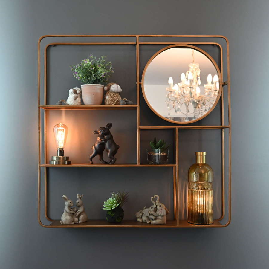 Gold metal wall shelving unit with round mirror